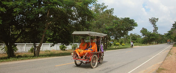 Buddhist monks on the highway near Sukhothai
